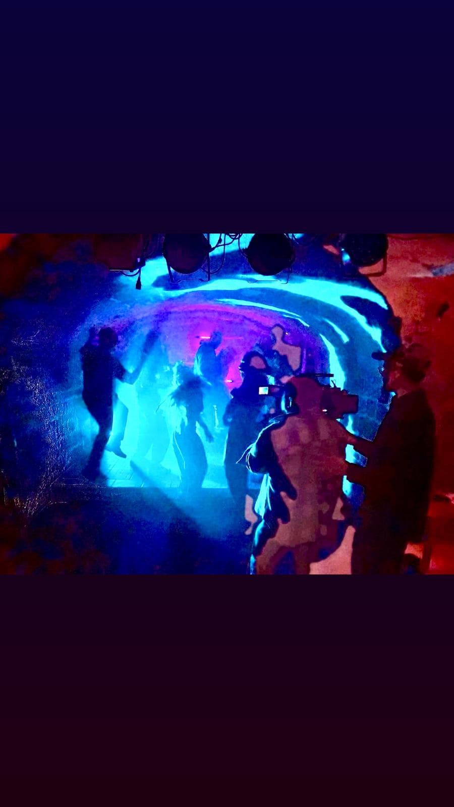 A film set lit in deep blue and red — atmospheric cinematography