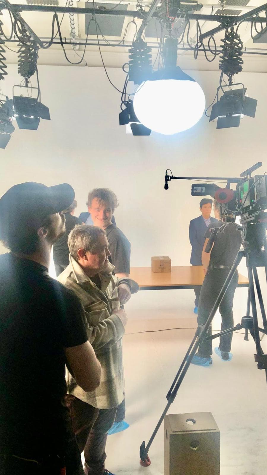 Paco Wiser mentoring a student crew on a fully lit film set